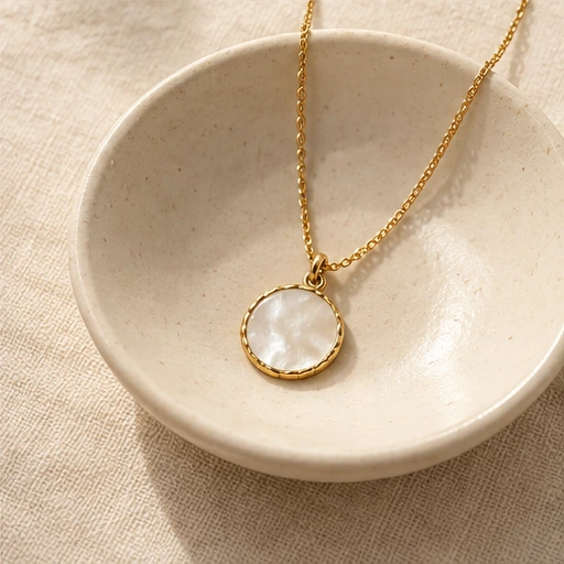 Collier à pendentif nacré dans une coupelle artisanale